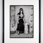 framed 1960s black and white photograph of two women and one young girl, woman on the left is wearing a white embroidered dress and the woman on the right wears a black embroidered dress