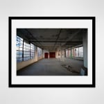 Black framed photograph of a loft space is unfurnished and completely vacant