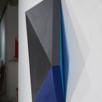Detail of Tridimensional painting of a black & navy blue prism with triangular sides, looking like a cut gem