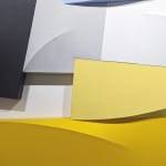 Detail of Tridimensional, bas relief horizontal painting made of interconnected trapezoid shapes (yellow, gray, blues, black)