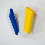 Detail of Tridimensional painting of two interconnected white rectangular prisms with colored sides (blue, yellow)