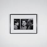 Framed Black and white photograph of Andy Warhol in profile in front of a screen print of a man’s mug shot