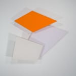 Tridimensional painting of interconnected parallelograms in orange, white, and beige