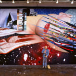 Photograph of James Rosenquist sweeping in front of a mural of a woman’s face and strips of bacon in a galactic scene