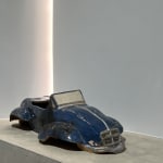 Sir Terence Conran, A glazed pottery model of a blue sports car, together with two clay modelled busts reputedly made...
