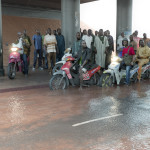 Oil workers (from the Shell company of Nigeria) returning home from work, caught in torrential rain