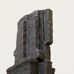 Detail of a bronze sculpture of an abstract form.