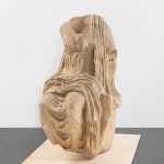 Marble sculpture of a headless female figure.