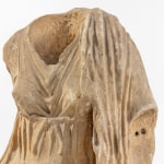 Marble sculpture of a headless female figure.