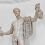 A detail of a pentelic marble sculpture depicting the mythological story of Perseus beheading Medusa.