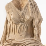 Marble sculpture of a headless female figure.