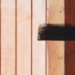 Detail of an abstract oil painting in brown, cream and black.