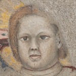 Detail of a ripped fresco of the Virgin Mary in Majesty holding Jesus Christ. The detail shows the face of Jesus.