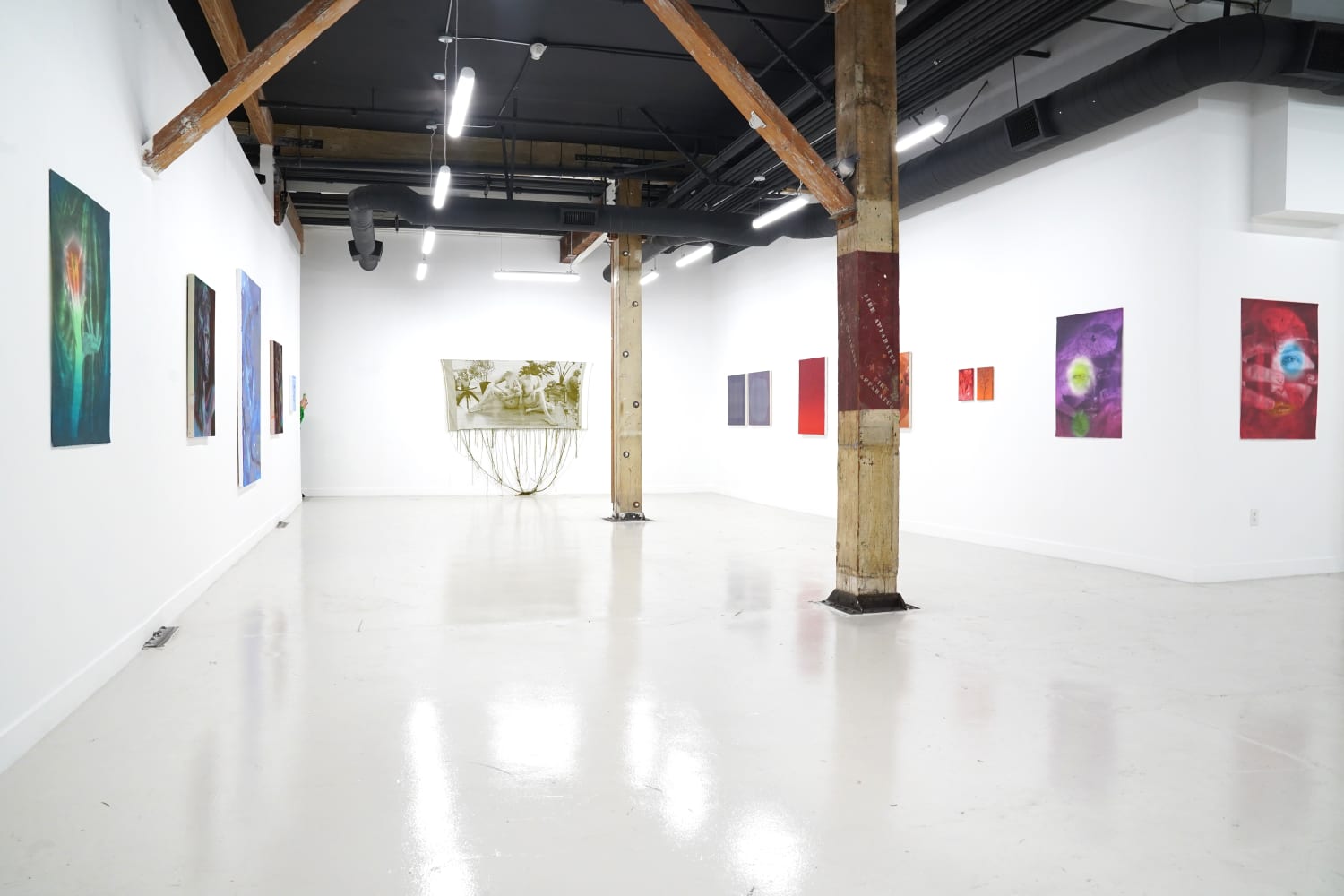 photo of the gallery layout with a monochromatic themed art exhibition installed