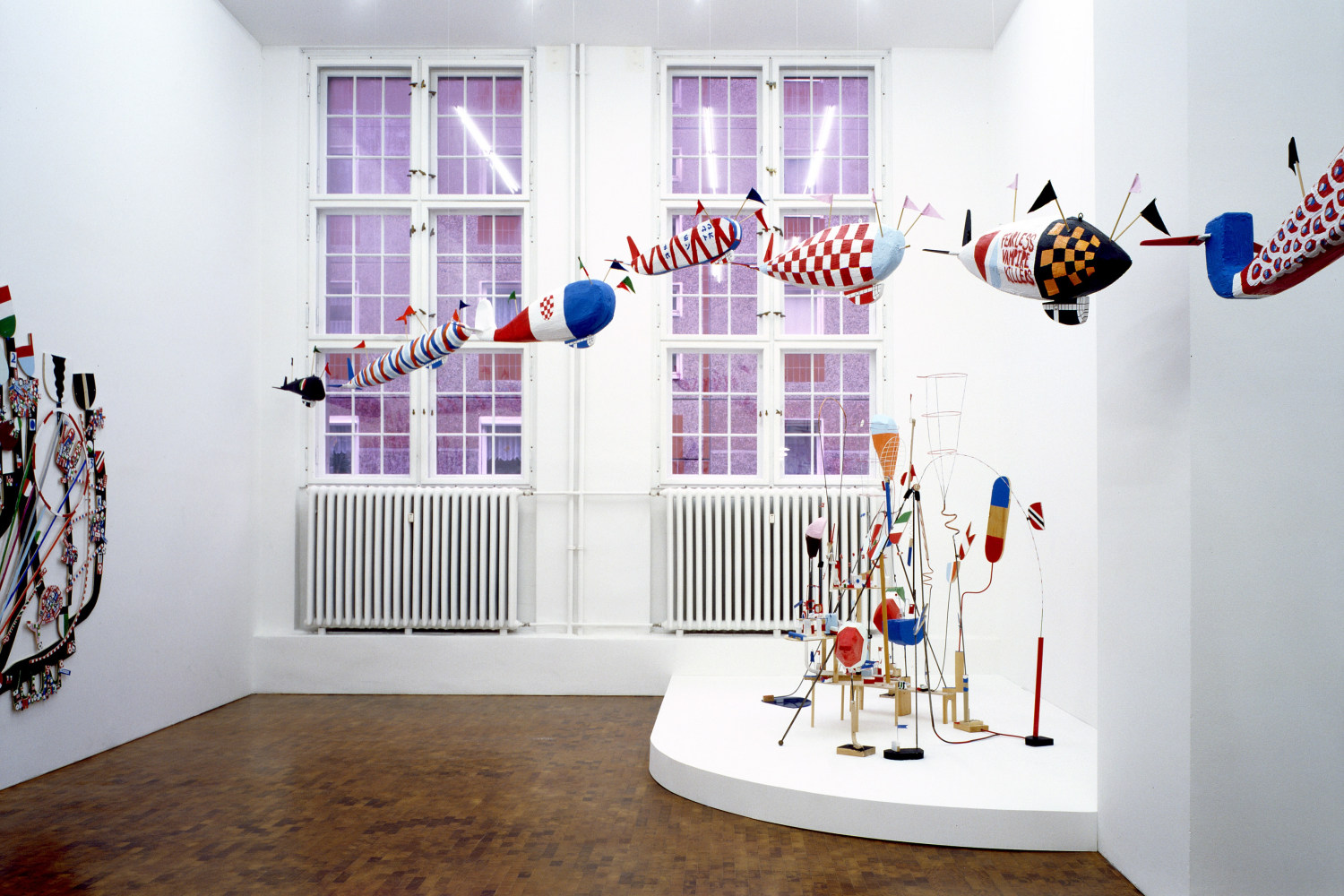 Exhibition view: THE GALE FORCE PRECISION DIRIGIBLE FLYING FACTION IN ACTION, 2006 (left) Styrofoam, resin, acrylic paint, wood, wire, fabric,...