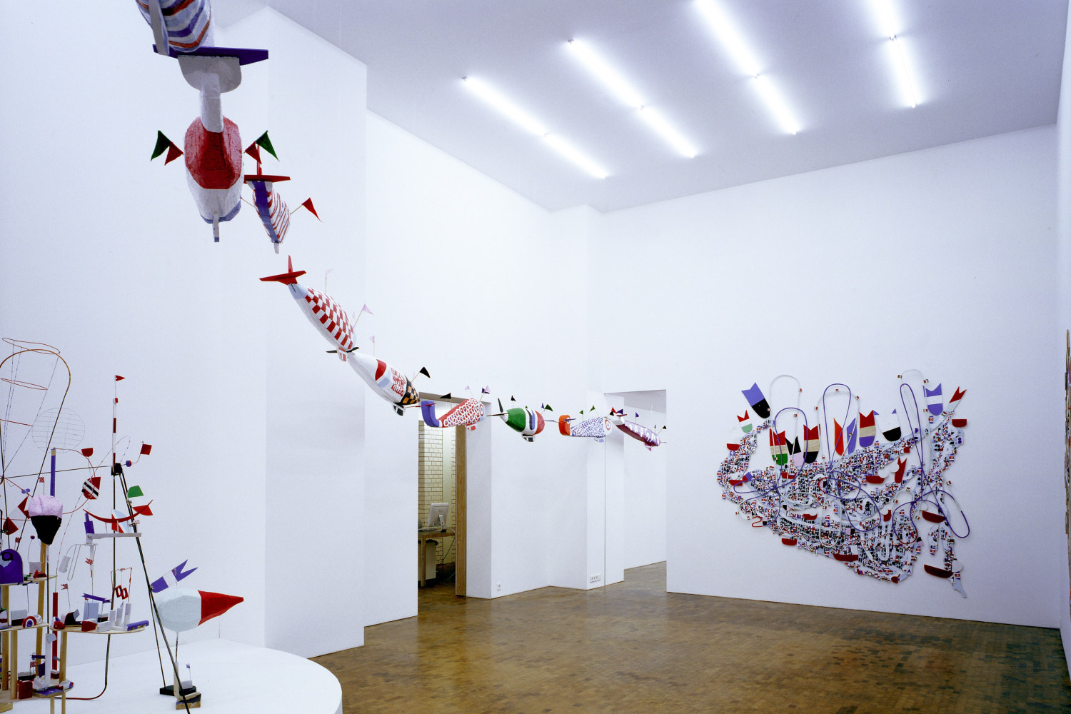 Exhibition view: THE GALE FORCE PRECISION DIRIGIBLE FLYING FACTION IN ACTION, 2006 (left) Styrofoam, resin, acrylic paint, wood, wire, fabric,...