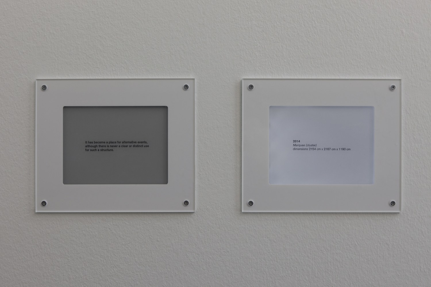 Flickering Labels, 2013 Electronic paper, 2 parts Programmed to vary in brightness and to display text that scrolls in changing...