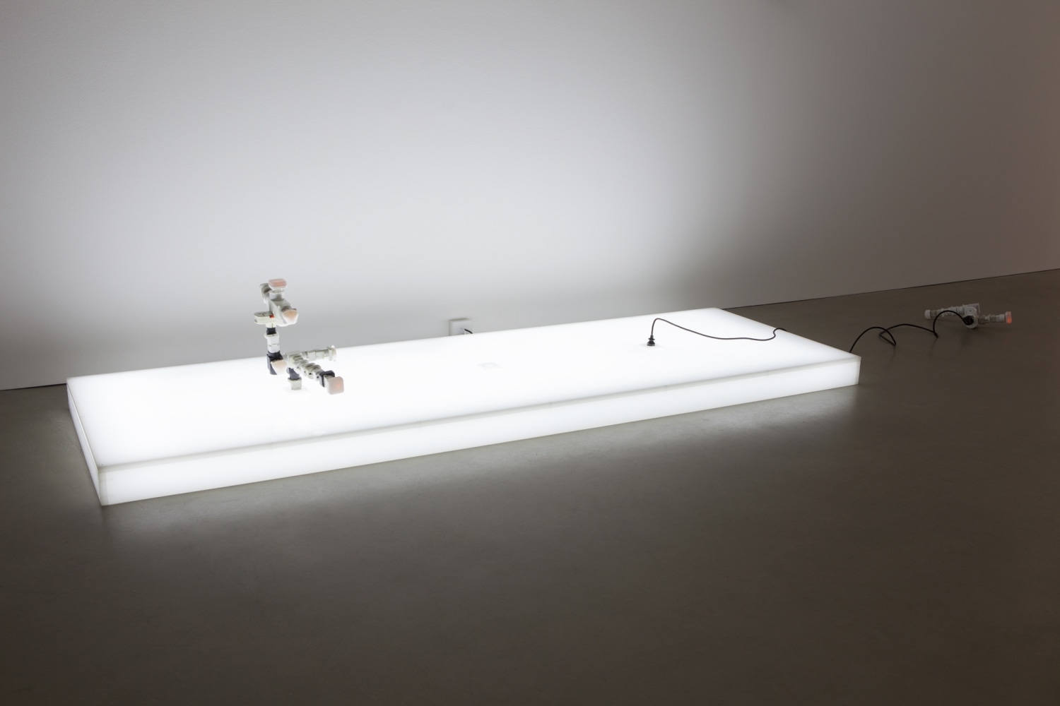 AC/DC Platform, 2013 Opalescent acrylic glass podium, LED lights, 3 plugs, 2 AC/DC snakes Assembled from multiple adapters, plugs and...
