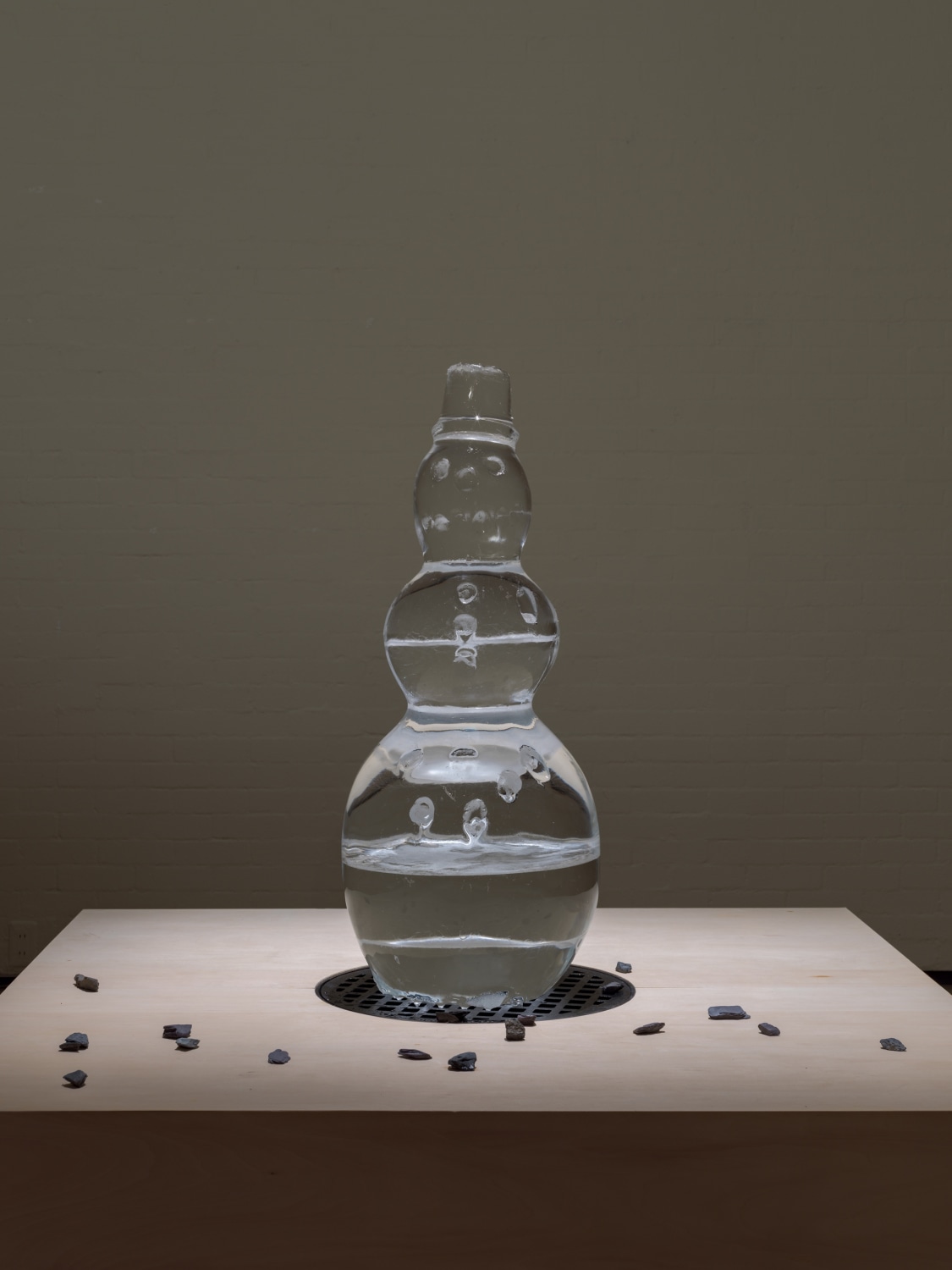 Iceman in Reality Park, 1995–2019 Sculpted ice, stones, plinth with a manhole, sound installation, protocol Dimensions variable Height: 117 cm...