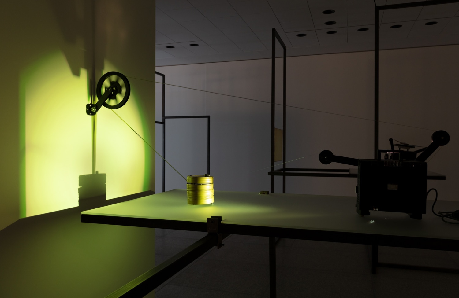 Rosa Barba Boundaries of Consumption, 2012 Transparent 16 mm film, modified projector, film canisters, 2 metal spheres Dimensions variable Exhibition...