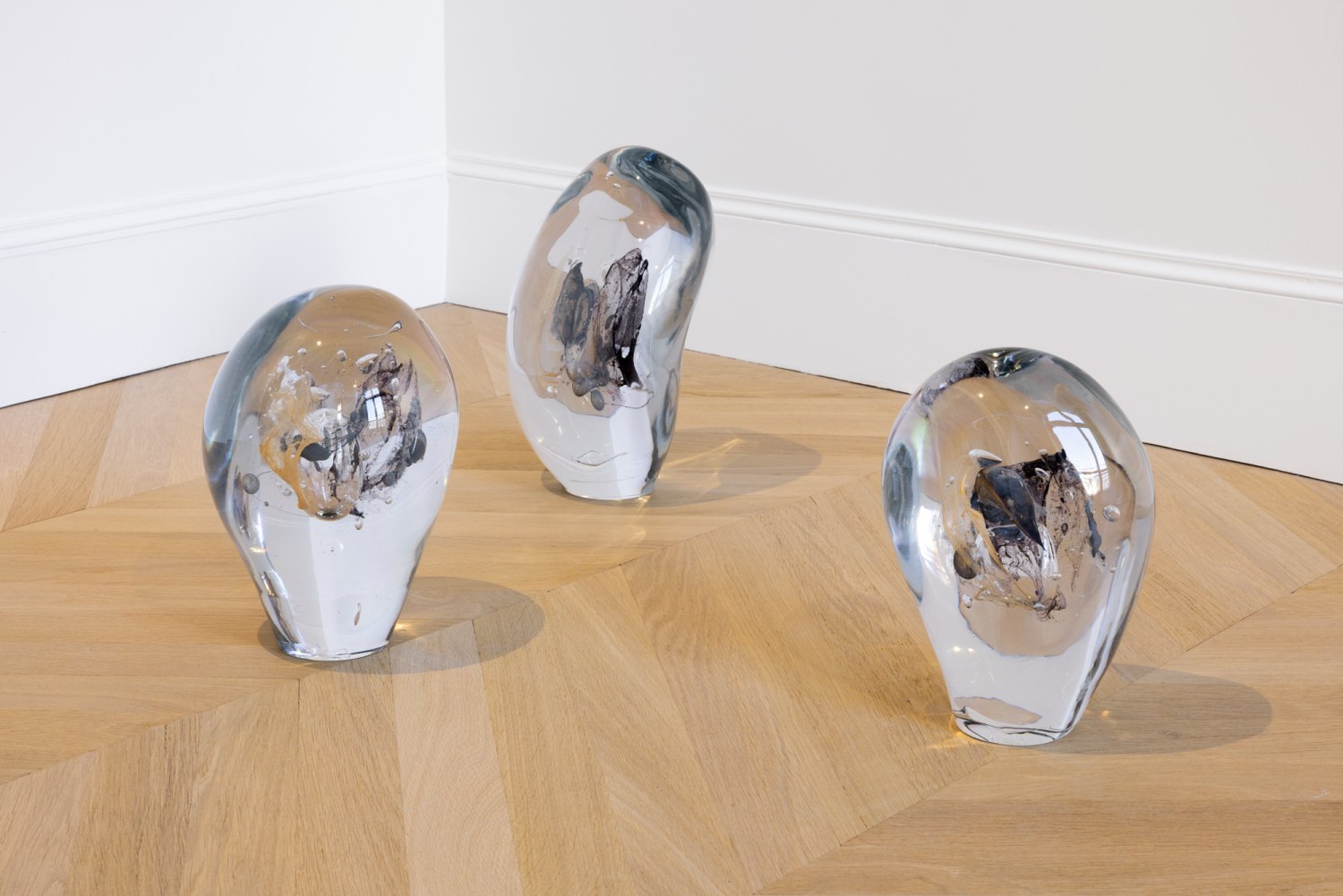 glass sculptures on a wooden floor
