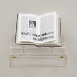 Tavares Strachan, Encyclopedia of Invisibility (Pocket Guide), 2024, leather, gilding, archival paper, lucite box and stand, overall: 9 1/4 x 12 1/8 x 10 in., edition of 250, courtesy of the Artist and Marian Goodman Gallery (photo: Elon Schoenolz)