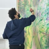 Julie Mehretu working in her studio , image courtesy and © Julie Mehretu , photograph: Sarah Rentz