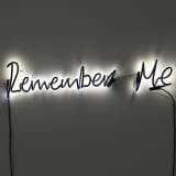 A neon sculpture by Steve McQueen that reads "Remember Me."