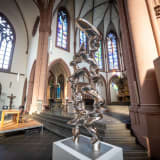 An image containing a sculpture by Tony Cragg, installed inside of a church.