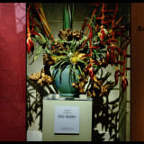 Flowers and the word "Sackler" in a pigment print by Nan Goldin