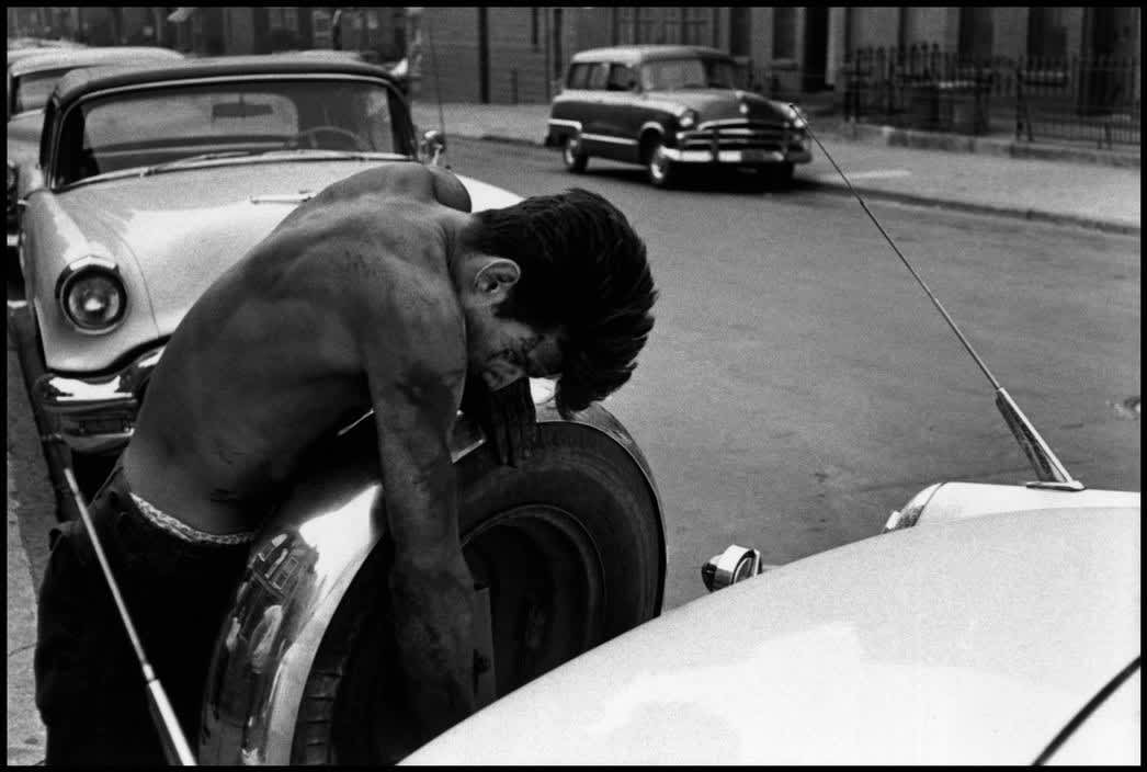 Bruce Davidson, Brooklyn Gang (teenage boy working on Cadillac Coupe de Ville), 1959
