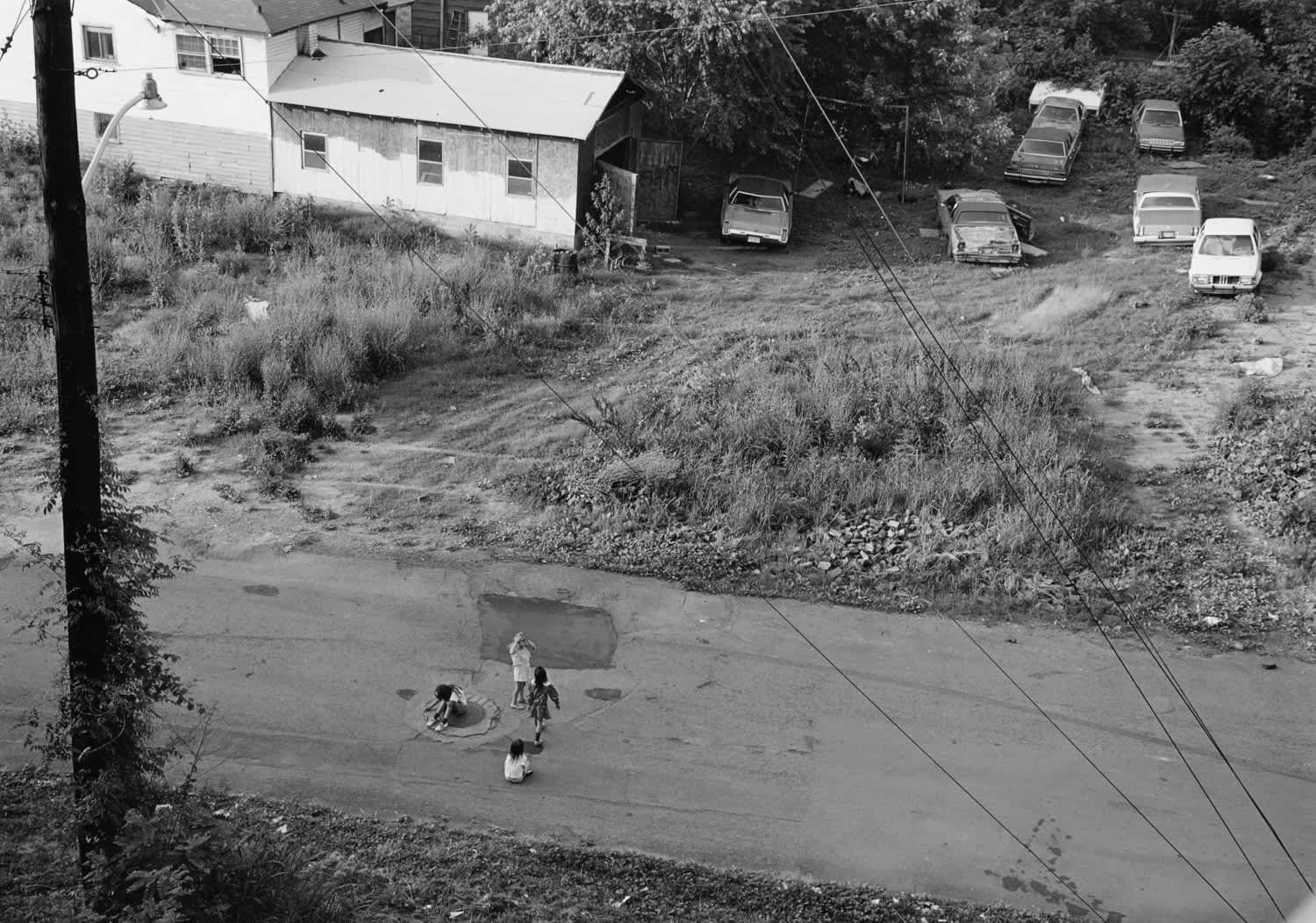 Mark Steinmetz, Knoxville, Tennessee, (Four Girls around a Manhole Cover) , 1992