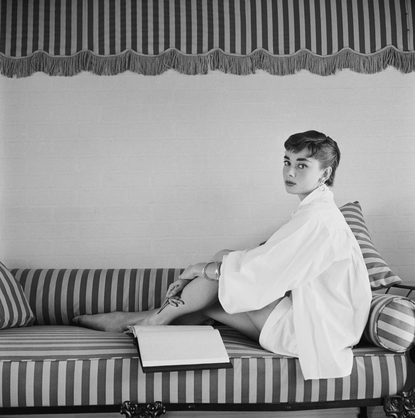 Mark Shaw, Audrey Hepburn on Striped Sofa