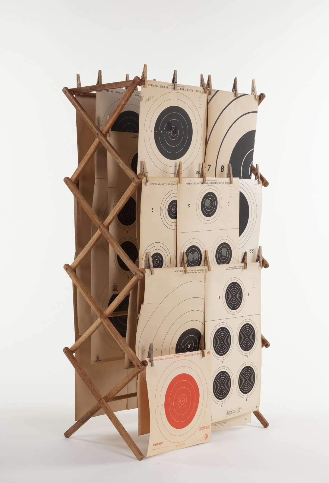 Lonnie Holley, Hung Out III, 2020, wooden clothes rack, wooden pegs and paper rifle targets, 144.5 x 75.5 x 42 cm