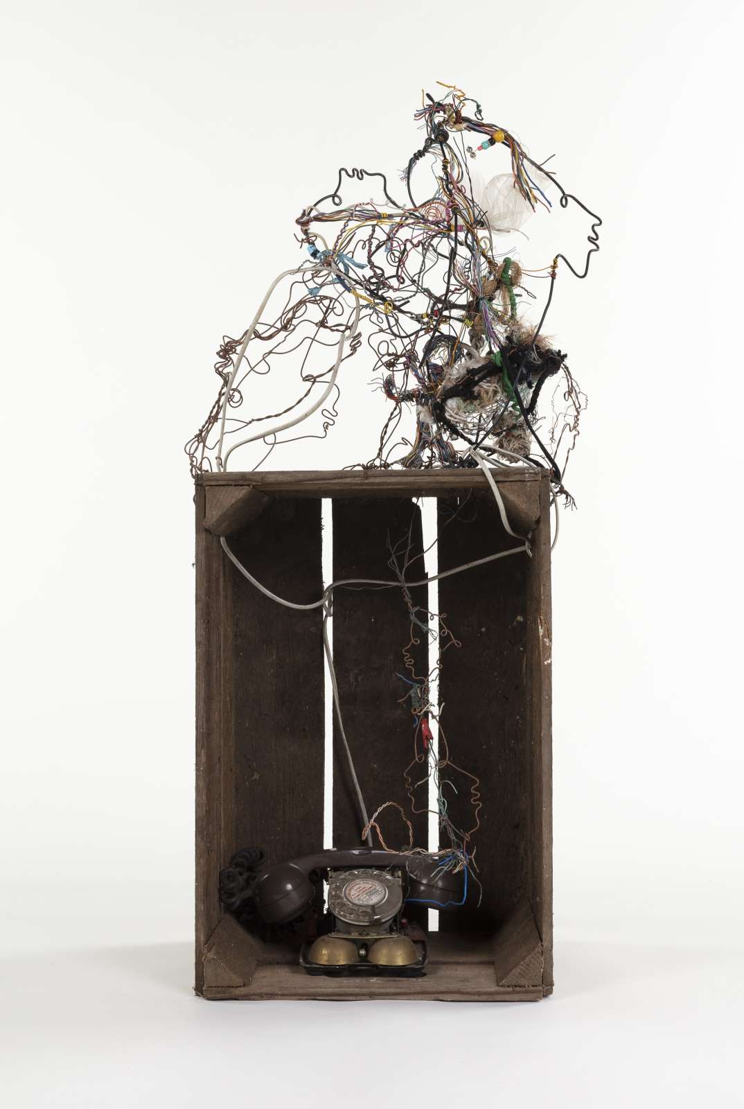 Lonnie Holley, The Growth of Communication, 2022, wooden milk crate, telephone, cotton thread, telephone cables and wire, 98 x 44 x 30 cm