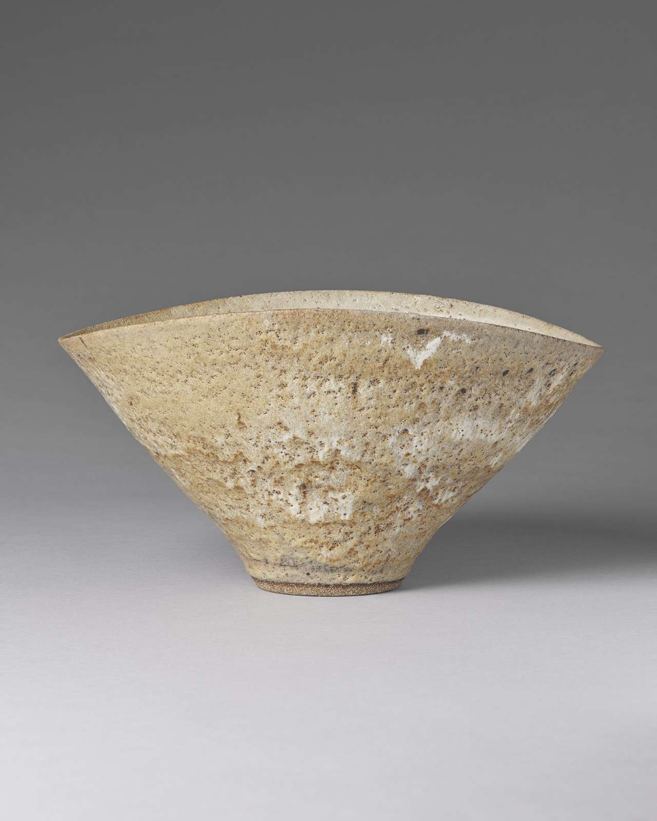 Lucie Rie, Large Squeezed Bowl, 1972, impressed with the artist’s monogram, stoneware with an all-over pitted glaze, Diameter: 33cm / 13 inches