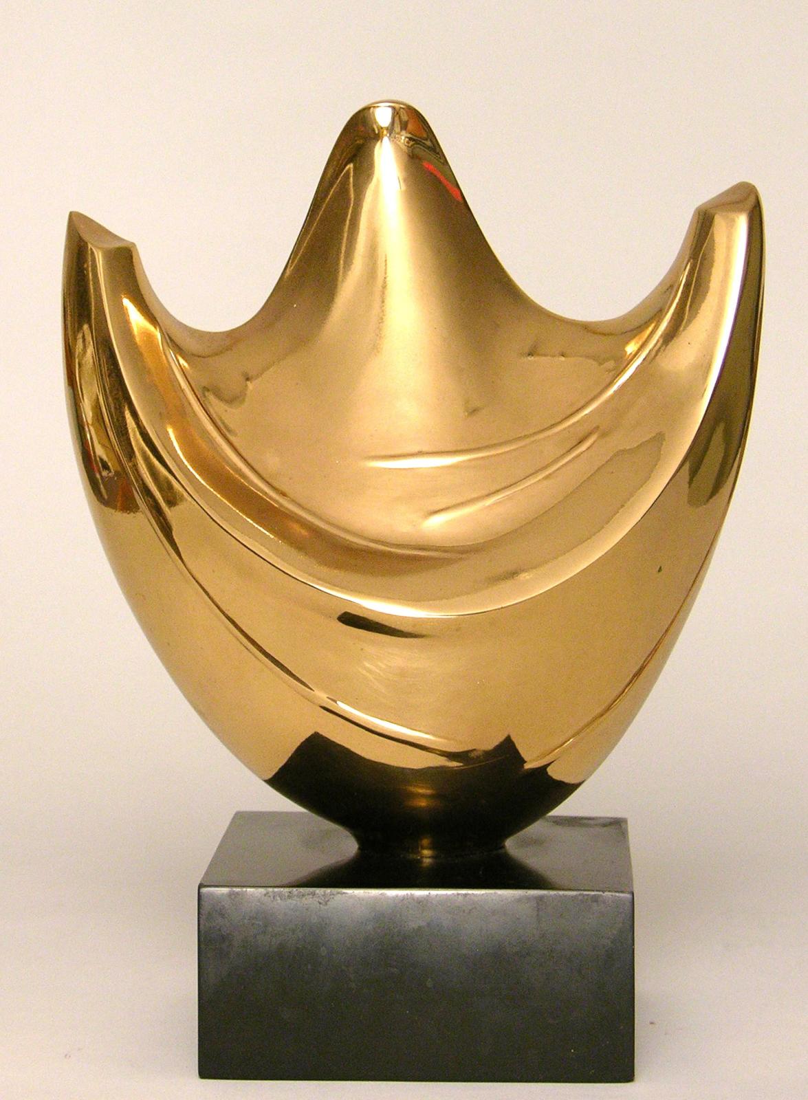 A polished bronze sculpture, an abstracted figure with arms raised