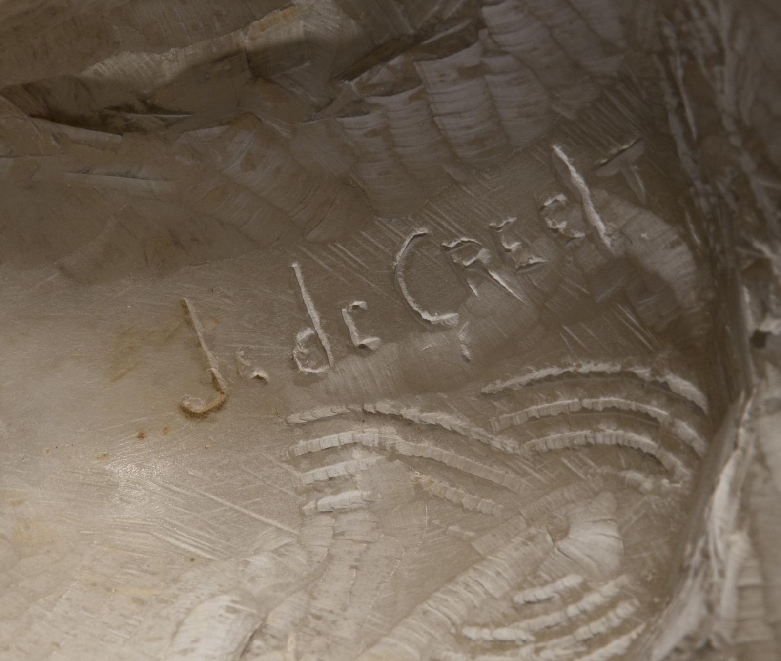 The signature on the rear of a figure of a crouching woman roughly hewn from a piece of alabaster