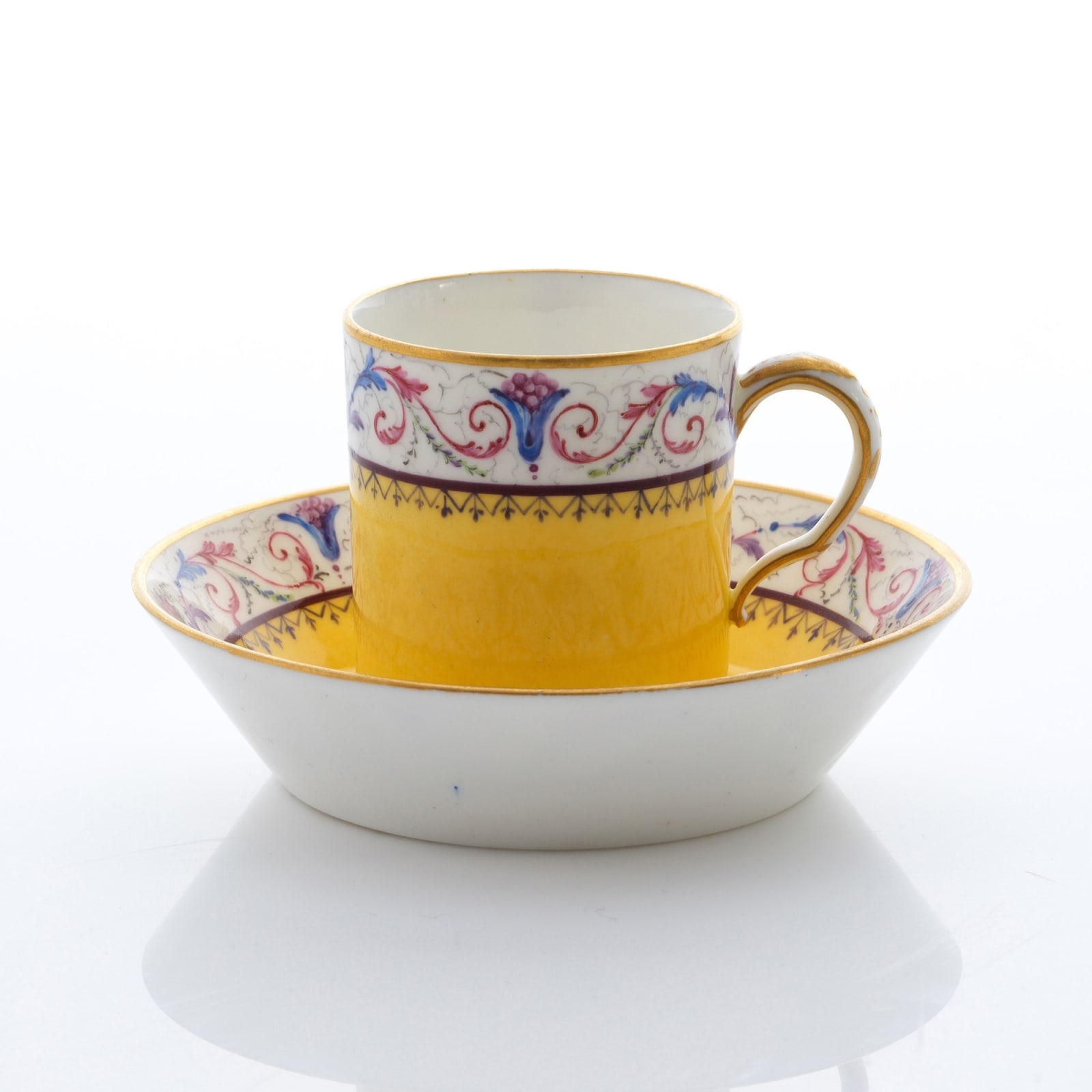 Sèvres Porcelain, A Soft-Paste Sèvres Porcelain Yellow Ground Cup and Saucer, 1789