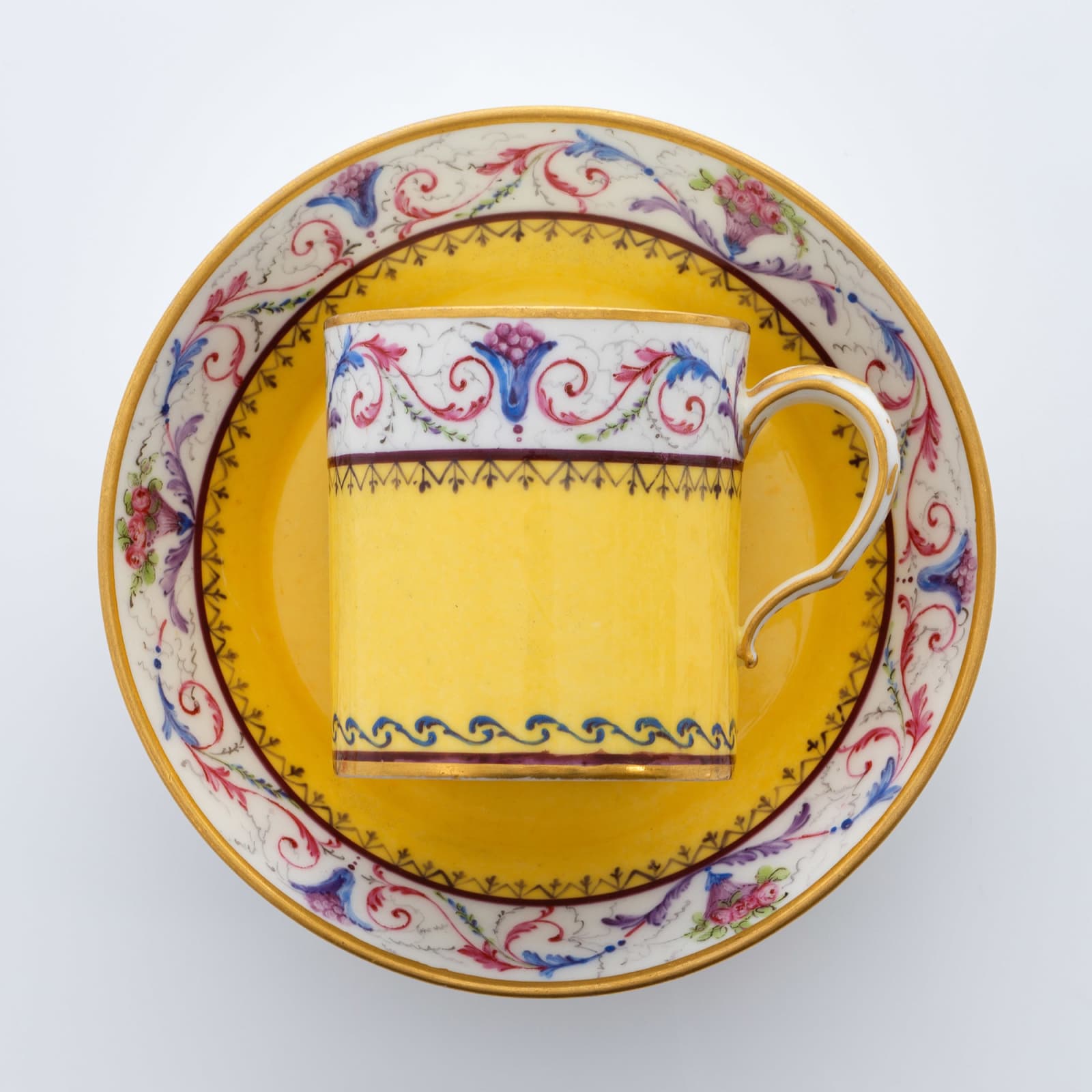 Sèvres Porcelain, A Soft-Paste Sèvres Porcelain Yellow Ground Cup and Saucer, 1789