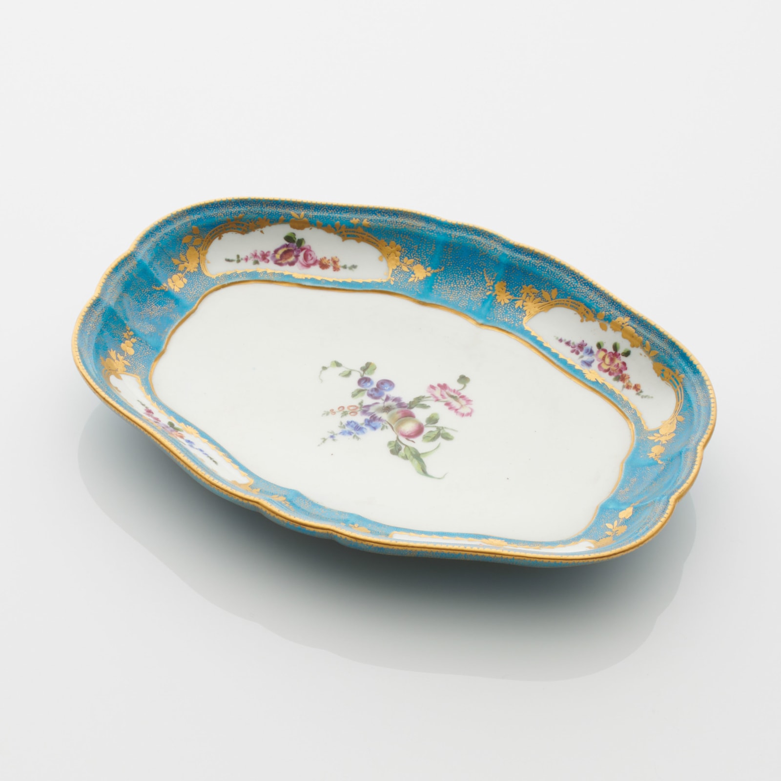 Sèvres Porcelain, A Soft-Paste Vincennes Porcelain Dish with bleu céleste sablé d’or ground, 1754