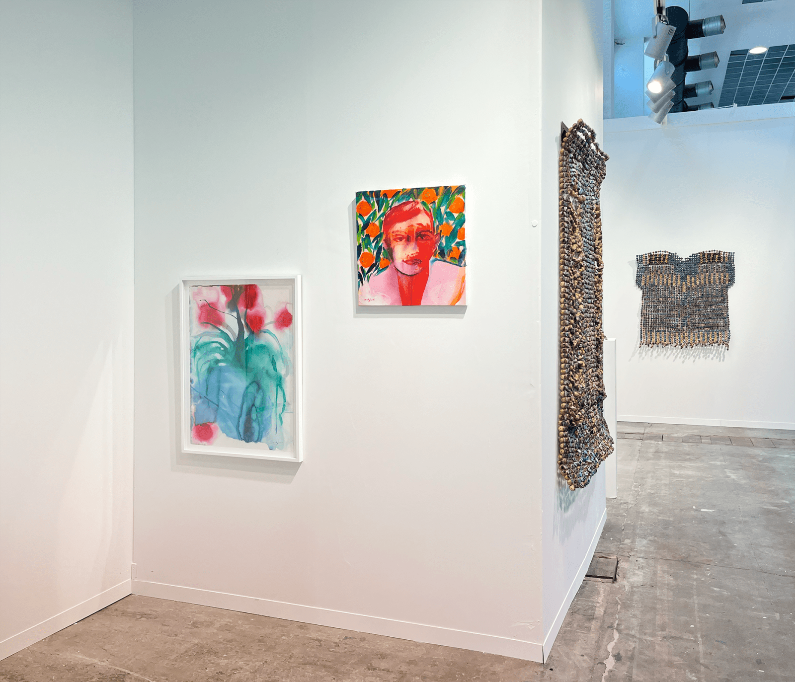 View of AFIKARIS booth at Art Brussels showing works by Omar Mahfoudi and Ozioma Onuzulike