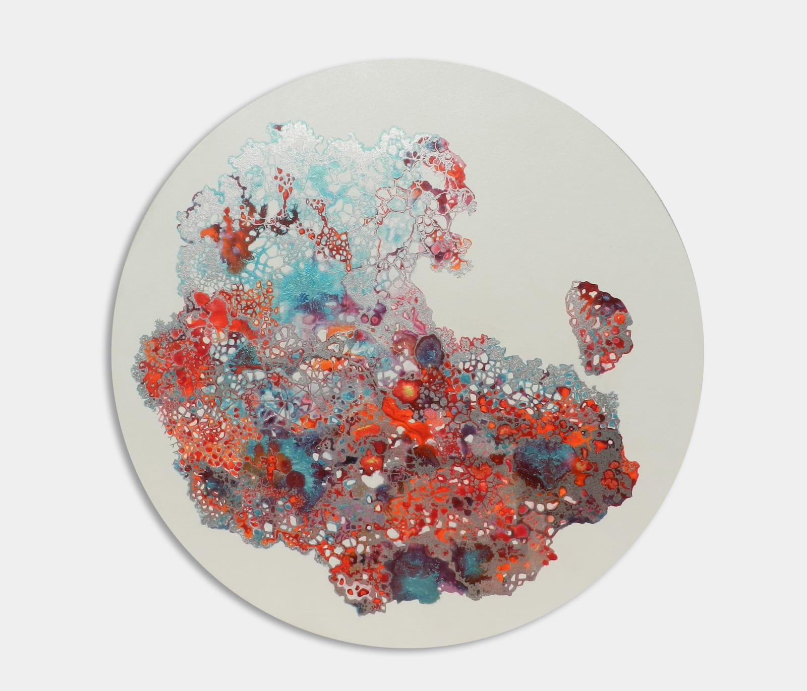 An abstract work on a circular canvas made by Dhara Mehrotra in multiple colours including red, orange and blue showing the underground network of roots.