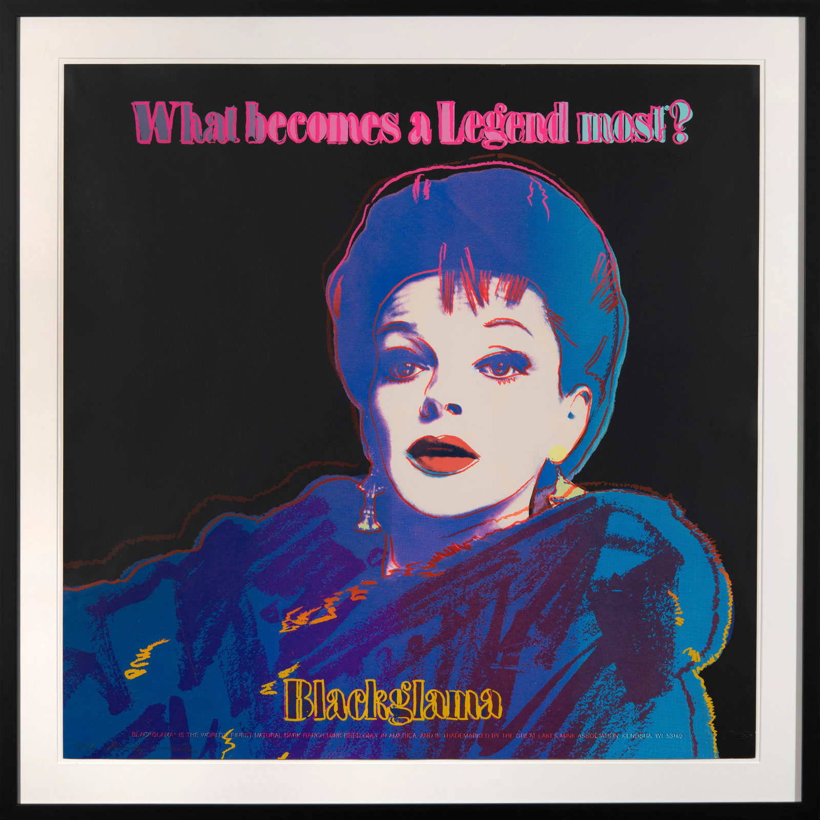 Andy Warhol screenprint of Judy Garland wearing a neon blue and purple fur coat and same coloured hair on black background in black frame