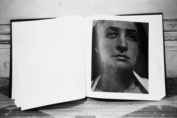 Judy Linn black/white photograph depicting open book with blank left page and portrait of Georgia O'Keeffe on right.