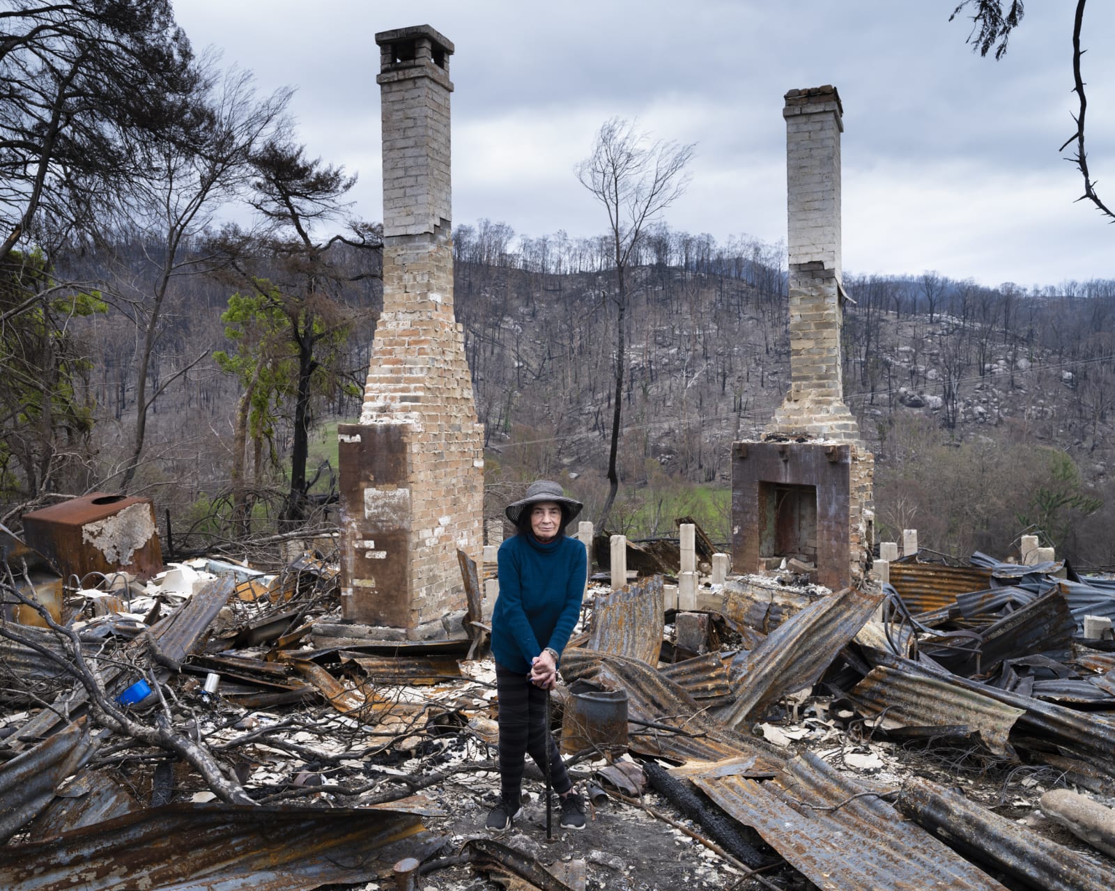 Gideon Mendel, Carol Schaefer at her burnt home in Yowrie, New South Wales, 2020