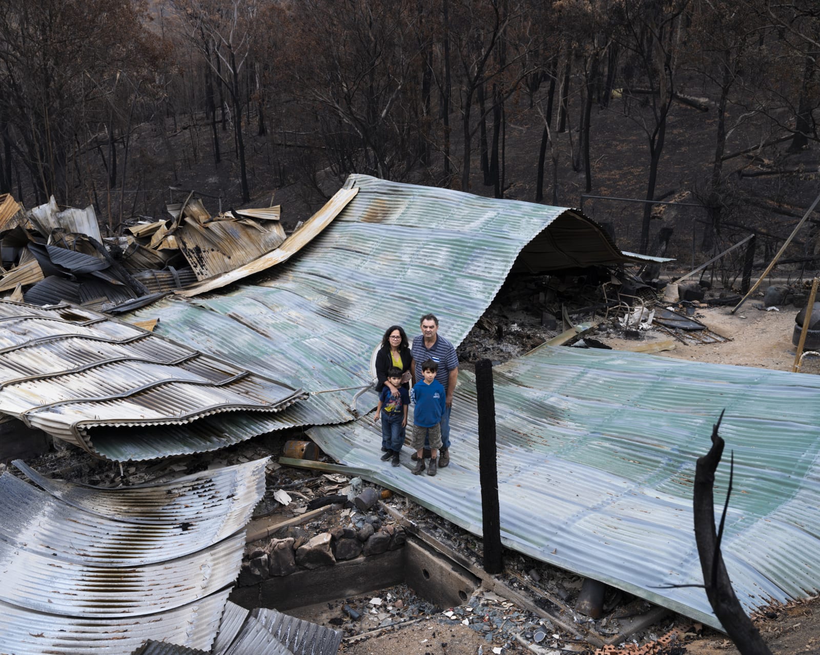 Gideon Mendel, The Montagner family at their burnt home in Upper Brogo, New South Wales, 2020