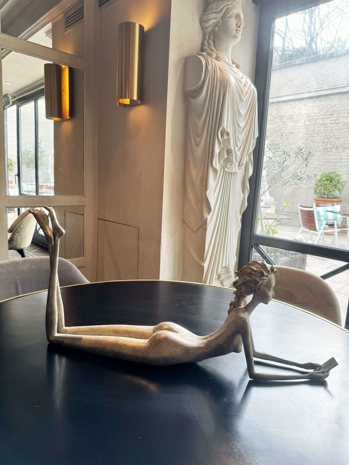 Ich vermisse dich, Frauenskulptur Hedwige Leroux zeitgenössische Skulptur Bronzeskulptur Frau mit in den Wind wehenden Haaren Innenarchitektur im Hotel Barsey von Warwick Art Yi Galerie Brüsseler Kunstgalerie