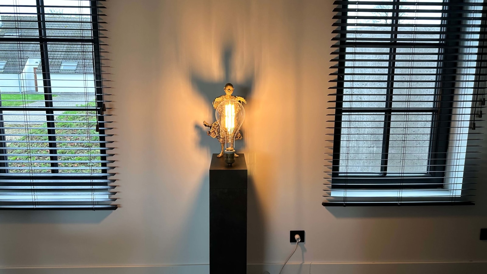 IIXV Visionary XL with light boy sculpture bronze sculpture of Lieven d'Haese garden sculpture boy opening arms to light up a light bulb in his hands with imagination magic dream contemporary art sculpture light interior design at Art Yi gallery in Brussels