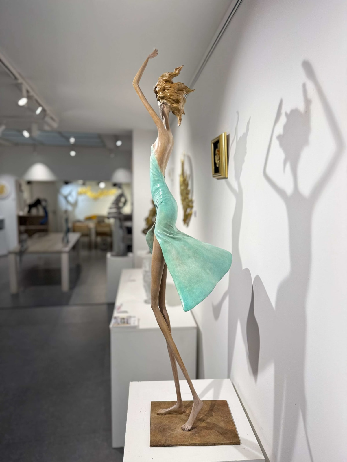 Moonlight dancing girl sculpture of Hedwige Leroux contemporary bronze sculpture dancer woman sculpture a girl in a green dress dancing freely Art Yi gallery in Brussels